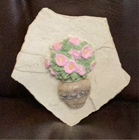 Hand cast concrete small Daisy on a rock wall tile