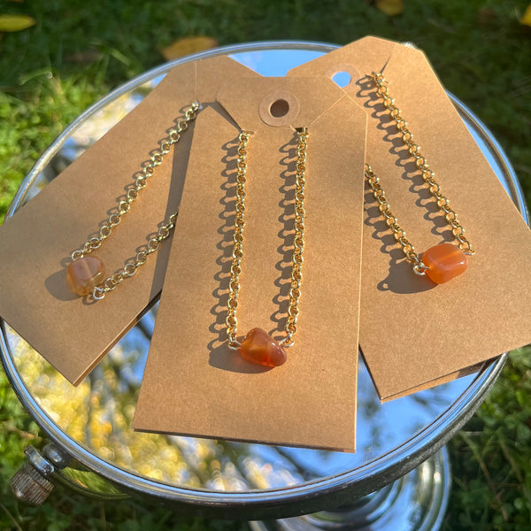 Gold necklace with red agate stone