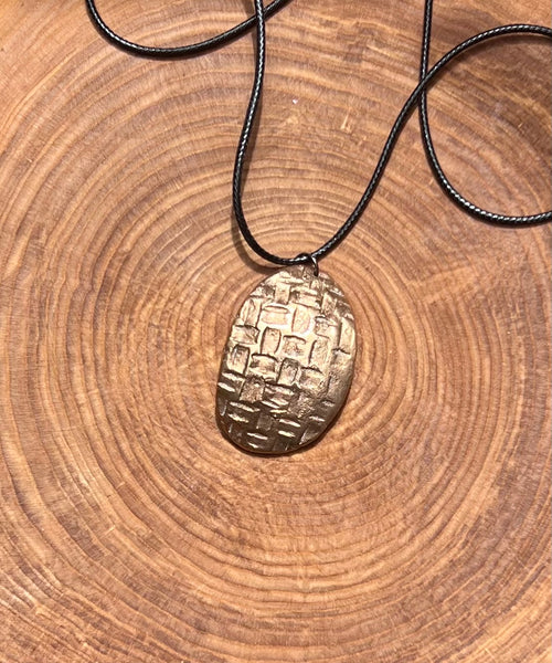 Woven shield of Bronze pendant - by Leslie Welfare