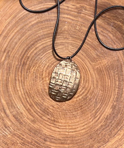 Woven shield of Bronze pendant - by Leslie Welfare